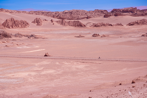 Biking in the dry and hot landmark Moon Valley near San Pedro, Atacama.