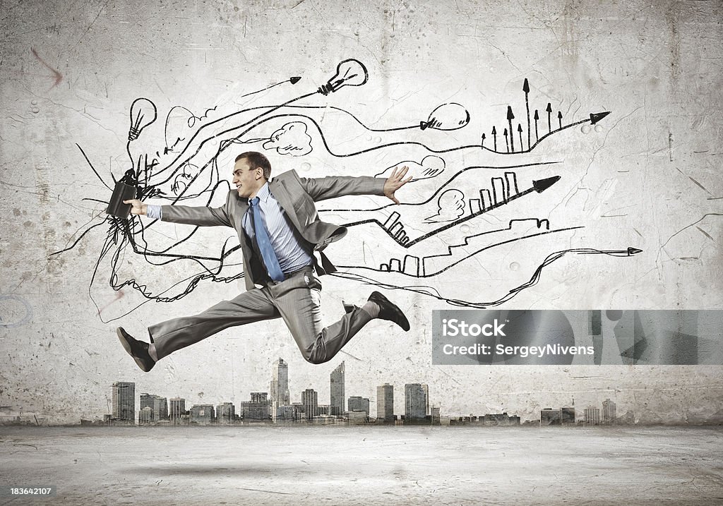 Jumping businessman Image of businessman in jump against sketch background Adult Stock Photo