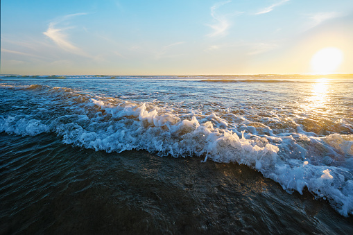 Atlantic ocean sunset with surging waves at Fonte da Telha beach, Costa da Caparica, Portugal