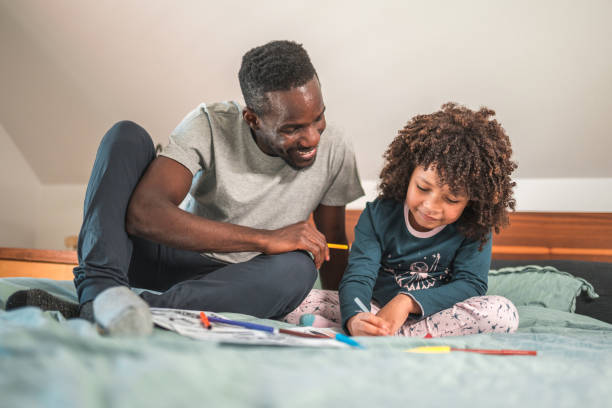 istock Smiling Black American Man and Little Son Having Fun Coloring Together 1836446112