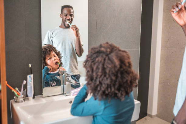 istock Preschool African-American Boy Cleaning Teeth With Dad 1836446130