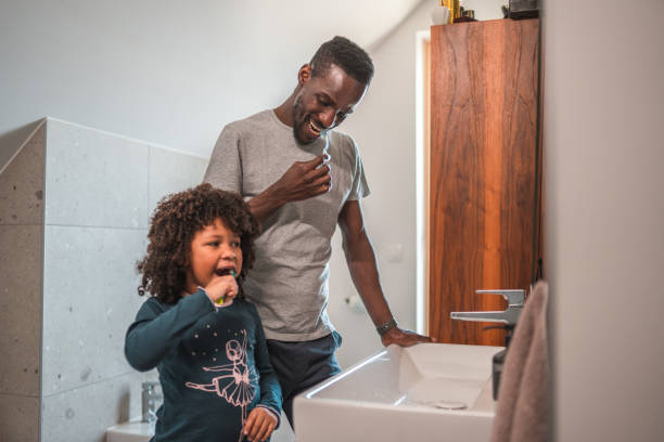 istock Smiling Black Male Single Parent With Small Boy Cleaning Their Teeth 1836446242