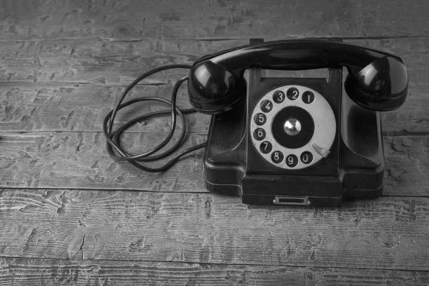 istock An antique telephone set on a black wooden table. 1836449322