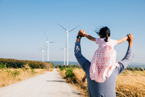 istock Father joyfully carries daughter exploring wind farm 1836456649
