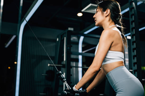 istock Slim and strong young woman working out on a pull-down weight machine 1836456672