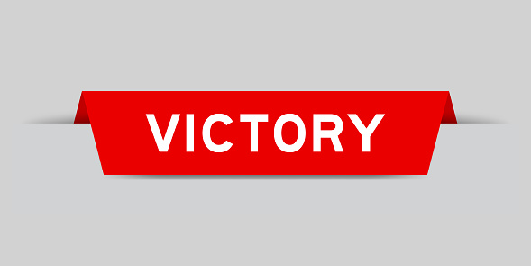 Red color inserted label with word victory on gray background