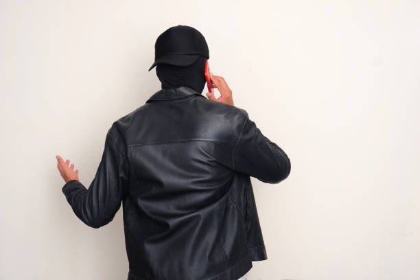 Back view of an online scammers calling his victim