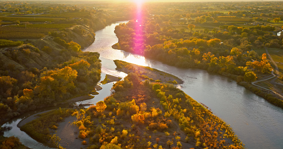 Aerial shot of Colorado River running through Palisade, a small town in Mesa County, Colorado, on a clear sunset in Fall.