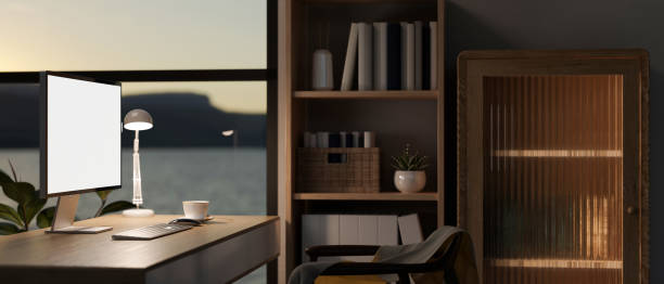 istock Interior design of a modern, luxury dark home office with a PC computer mockup on a hardwood desk. 1836531882