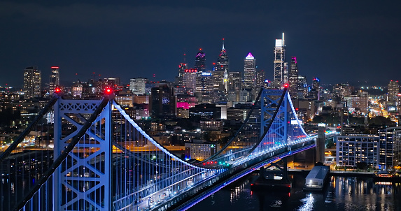 Aerial still image of Benjamin Franklin Bridge with the Philadelphia skyline in the background, on an overcast night in Fall.\n\nAuthorization was obtained from the FAA for this operation in restricted airspace.