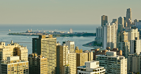 Aerial shot of Near North Side overlooking Navy Pier in the distance on a clear day in Chicago, Illinois.