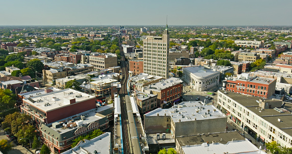 Aerial shot of subway train at Damen Station in Wicker Park, Chicago, Illinois on a clear day in Fall.