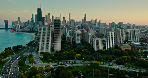Aerial shot of Near North Side from over Lincoln Park at sunset in Fall.