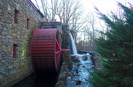 Working watermill wheel with falling water