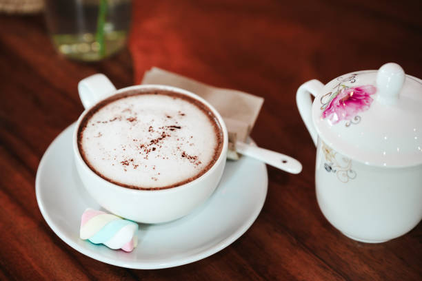 Hot coffee with soft milk foam on the table in a cafe.