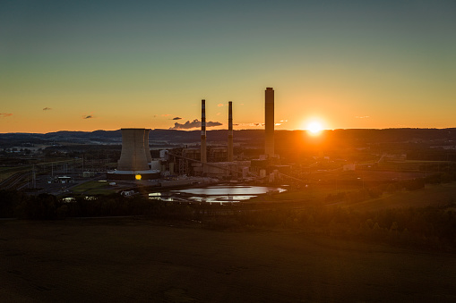 Drone shot of a coal fired power plant surrounded by farmland in Montour County, Pennsylvania at sunrise on a clear morning in Fall.