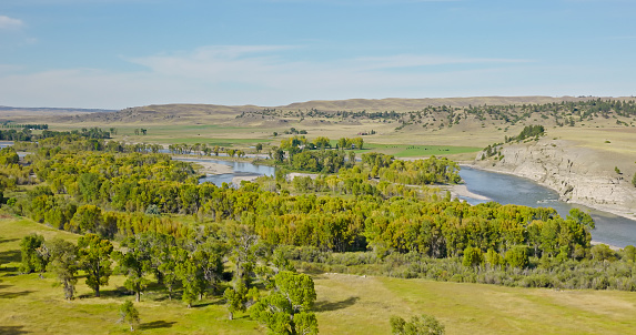 Aerial view of Yellowstone River in Greycliff, a census-designated place in Sweet Grass County, Montana, on a slightly cloudy day in Fall.