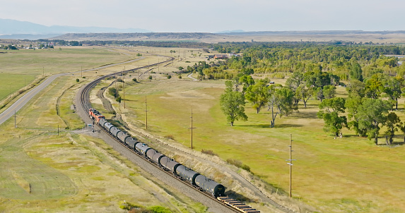 Aerial view of freight train in Greycliff, a census-designated place in Sweet Grass County, Montana, on a slightly cloudy day in Fall.