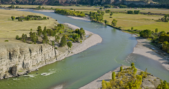 Aerial view of Yellowstone River in Greycliff, a census-designated place in Sweet Grass County, Montana, on a slightly cloudy day in Fall.