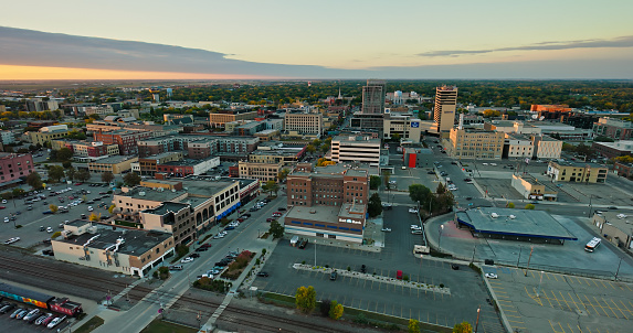 Aerial shot of downtown Fargo, North Dakota, on an overcast sunset in Fall.\n\nAuthorization was obtained from the FAA for this operation in restricted airspace.