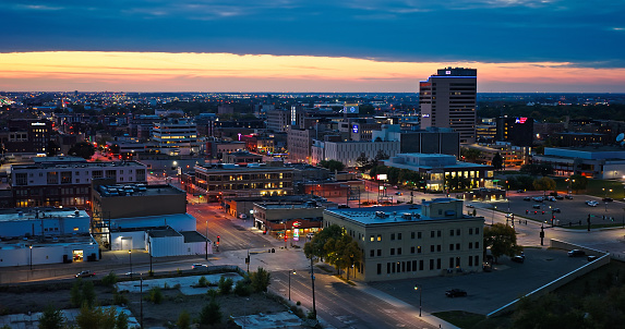 Aerial shot of downtown Fargo, North Dakota, on an overcast sunset in Fall.\n\nAuthorization was obtained from the FAA for this operation in restricted airspace.