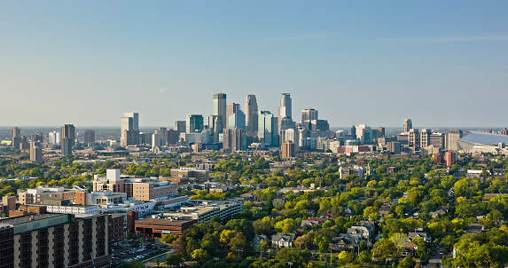 Aerial shot of Minneapolis, Minnesota on a clear evening in Fall from over residential streets and Abbott Northwestern Hospital in Phillips. \n\nAuthorization was obtained from the FAA for this operation in restricted airspace.