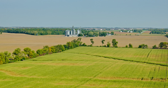 Aerial view of grain silos in farmland in Columbia County, Wisconsin, on a clear day in Fall.
