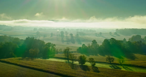 Aerial shot of rural scenery in Lycoming County, Pennsylvania, between the towns of Muncy and Pennsdale, on a misty morning in Fall.