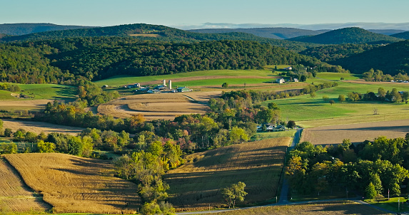 Aerial shot of rural scenery in Lycoming County, Pennsylvania, between the towns of Muncy and Pennsdale, on a hazy morning in Fall.