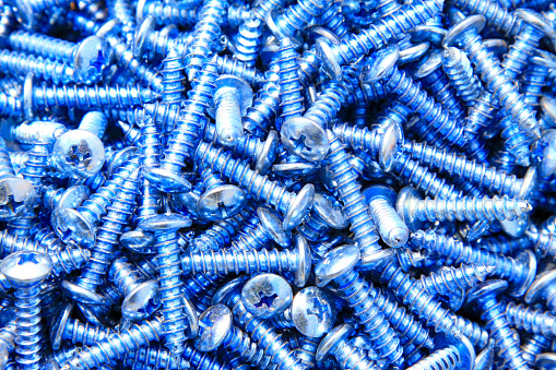 self-tapping screw piled up together, closeup of photo