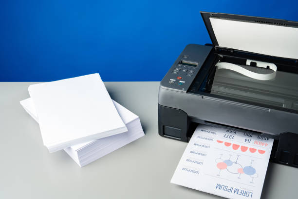 istock Laser printer on desk against blue background. 1836724479