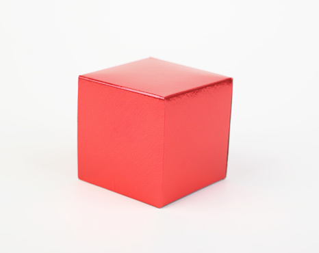 Red cube. Geometric icon isolated on white background. Symbol of stability