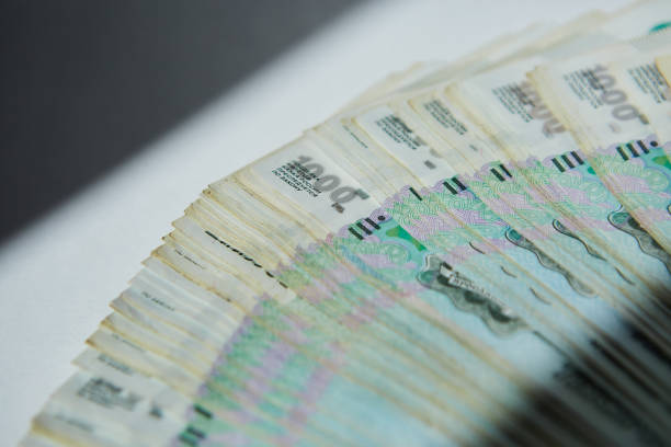 istock Russian banknotes of 1000 rubles face value are lying on a white surface, a large stack of money. Concept of economy and banking system. 1836754685