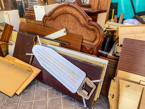 High angle close-up view of lots of furniture and wood planks in the street