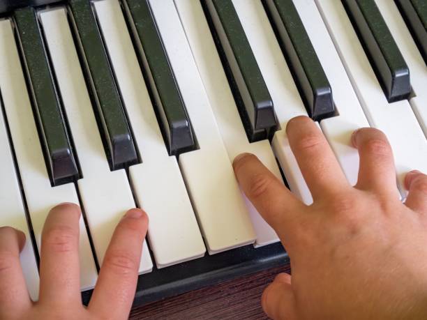istock Closeup of a child playing piano 1836773996