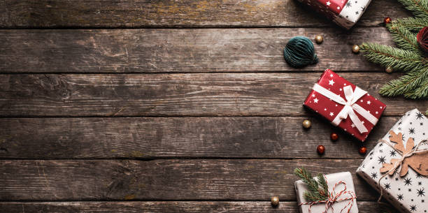 istock Christmas present on old wooden background.  many gift boxes and Christmas decor. 1836814630