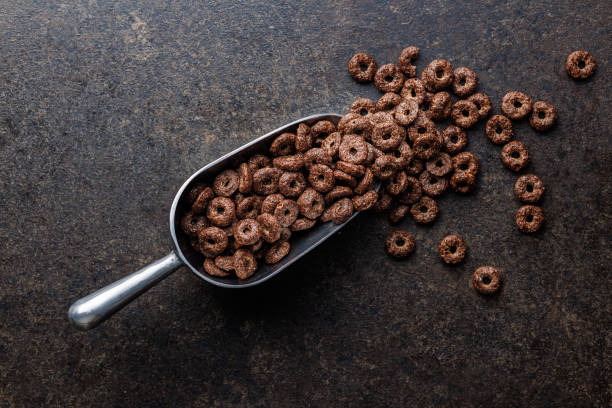 istock Sweet breakfast cereals in scoop on kitchen table. 1836832647