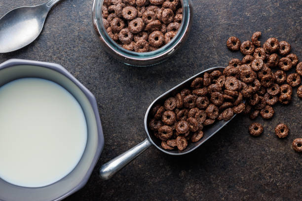 istock Sweet breakfast cereals in scoop on kitchen table. 1836832651