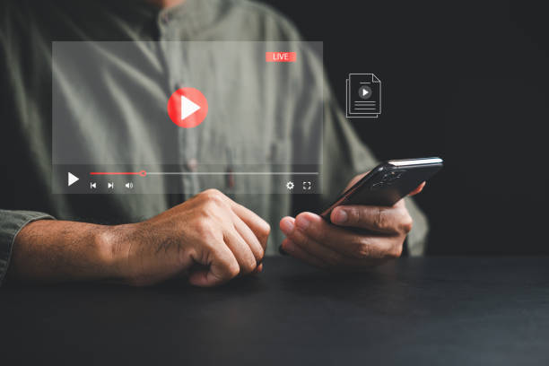 istock Man enjoying video streaming on virtual screen with a smartphone 1836862563
