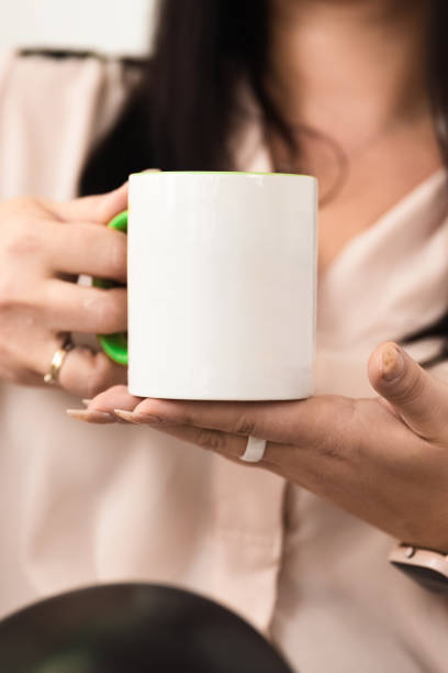 istock The girl holds a ceramic white mug in her hands 1836863088