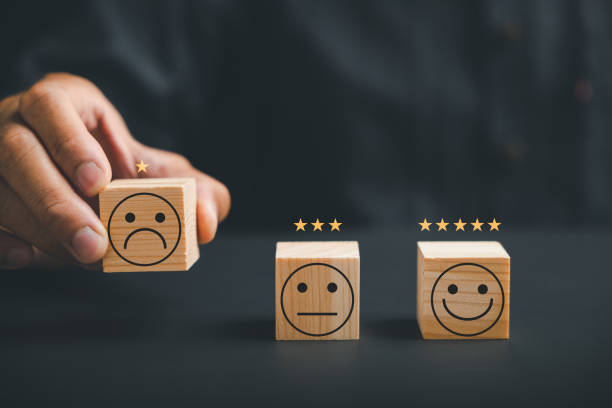 istock Unhappy customer hand with a sadness emotion face on a wooden block 1836864676