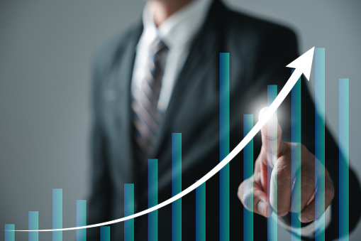 Embracing business analysis, financial investment, and tech concept, the journey from development to success is defined by growing growth. Financial graph on virtual screen illuminates the path.