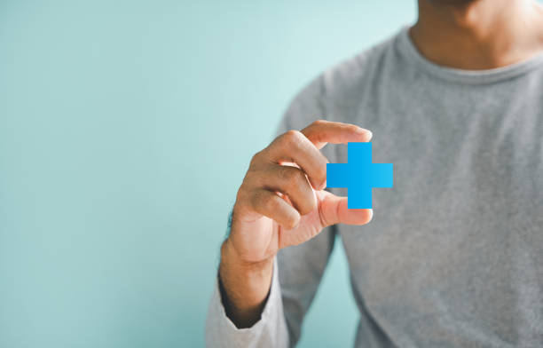 Hands holding plus and healthcare medical icon, symbolizing health insurance concept. Signifies access to welfare health and quality care. Showcases medical technology innovation.