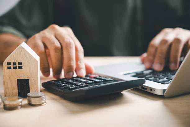 istock close up young man hand press on calculator to check 1836866386