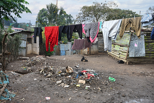 Drying laundry on narrow and dirty streets of slum in Nairobi. Kenya, Africa