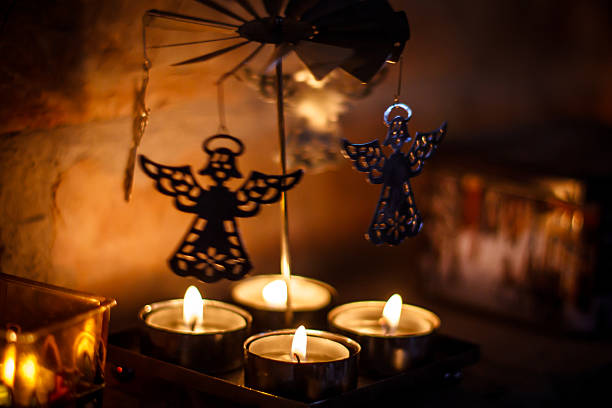 Lit candles and dancing angels stock photo