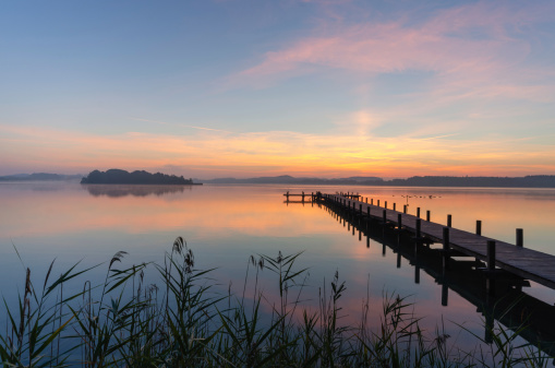 A wooden jetty at Woerthsee, photographed early in the morning.