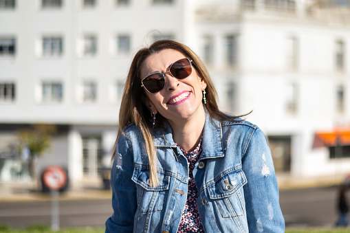 Portraits of a Charming Woman with a Cute Face. Female Posing for the Camera in the City Center. She Has a Wonderful Mood and a Perfect Smile.