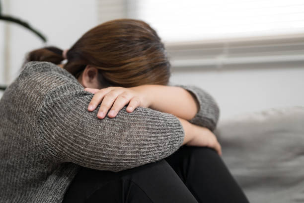 istock Sad Overweight plus size woman thinking about problems on sofa upset girl feeling lonely and sad from bad relationship or Depressed woman disorder mental health. 1836914199
