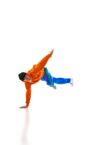 istock Young sportive man performing dance, hip-hop, breakdance elements in motion against white studio background in dace hall. 1836939874
